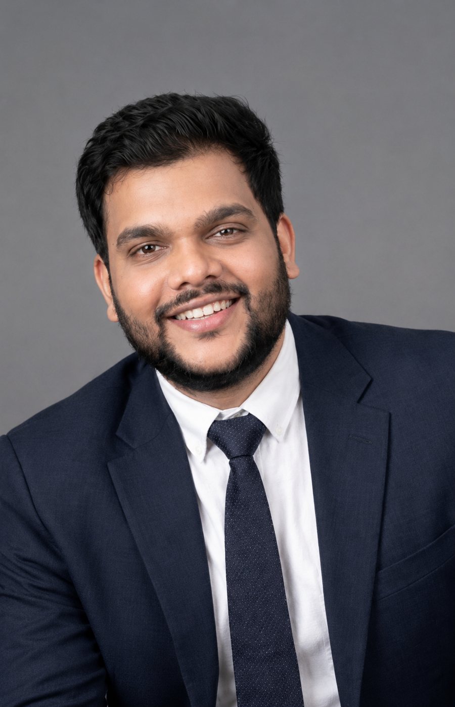 Shravan Teja Bagari, Founder and Chief Business Officer of Hive Realtors, smiling in a navy suit